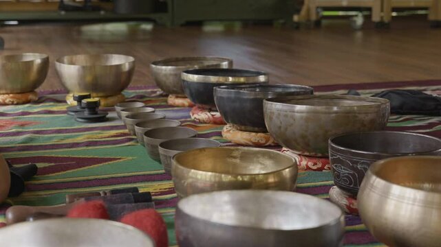 Tebet singing bowls stand on the floor before the start of the bowls ceremony in a gazebo on Bali Island