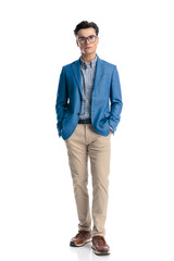 Fototapeta premium smart casual man with glasses holding hands in pockets and looking forward