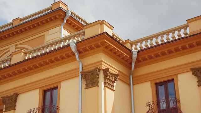 Architecture of Traku Voke Manor with fluttering flag on the top, under cloudy sky with sunlight