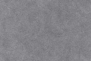 abstract dark gray grainy texture resembling asphalt, fine concrete, or sandpaper