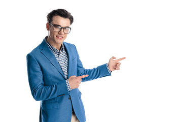 confident smart casual man pointing fingers to side and smiling