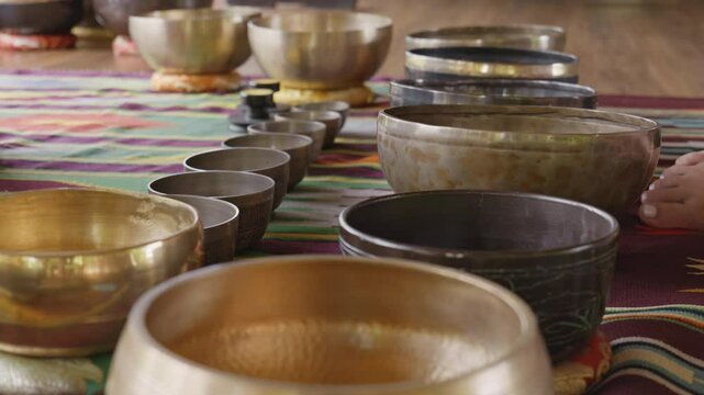 Tebet singing bowls stand on the floor before the start of the bowls ceremony in a gazebo on Bali Island