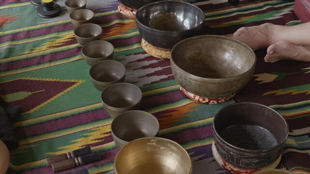 Tebet singing bowls stand on the floor before the start of the bowls ceremony in a gazebo on Bali Island