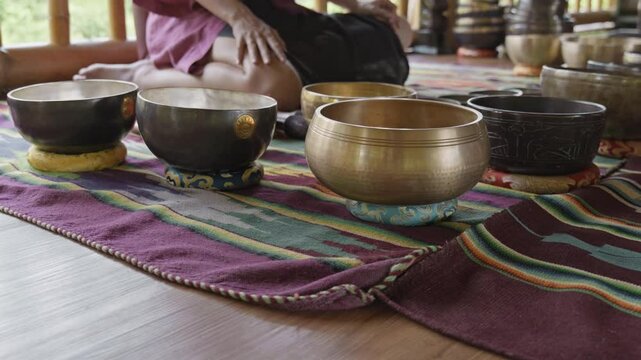 Tebet singing bowls stand on the floor before the start of the bowls ceremony in a gazebo on Bali Island