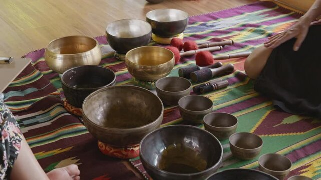Tebet singing bowls stand on the floor before the start of the bowls ceremony in a gazebo on Bali Island