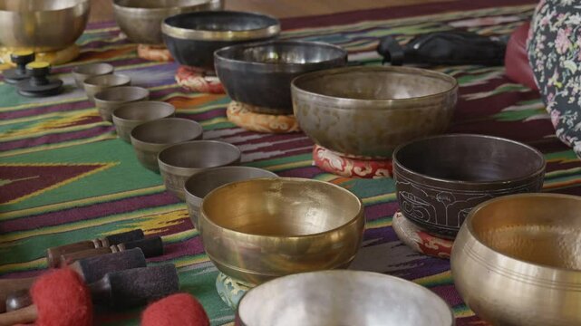 Tebet singing bowls stand on the floor before the start of the bowls ceremony in a gazebo on Bali Island