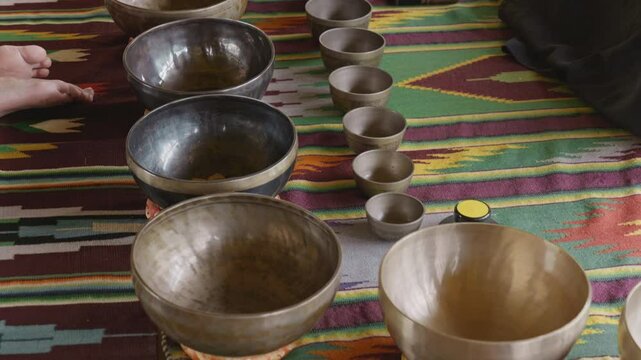 Tebet singing bowls stand on the floor before the start of the bowls ceremony in a gazebo on Bali Island