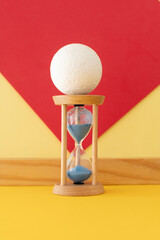 Hourglass with a flowing blue sand inside	