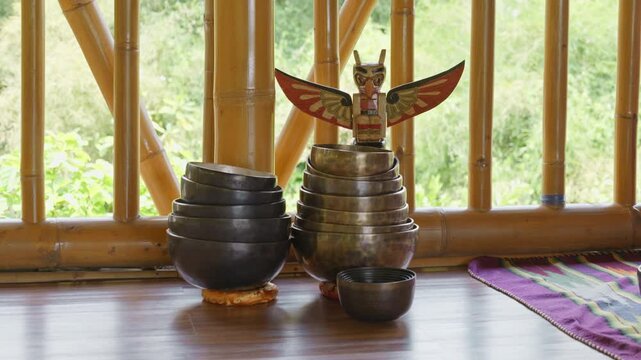 Tebet singing bowls stand on the floor before the start of the bowls ceremony in a gazebo on Bali Island