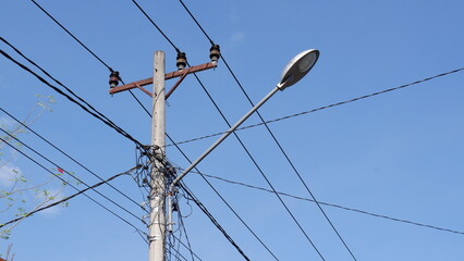 Tangled network of power lines on a utility pole