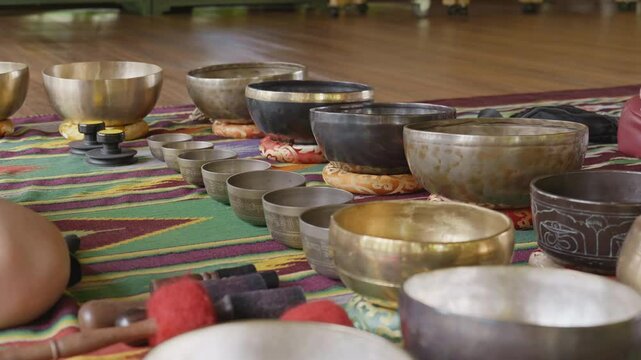 Tebet singing bowls stand on the floor before the start of the bowls ceremony in a gazebo on Bali Island