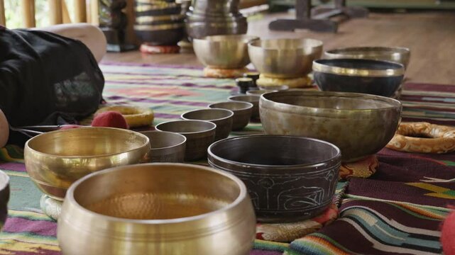 Tebet singing bowls stand on the floor before the start of the bowls ceremony in a gazebo on Bali Island