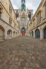 Wide view of a side entrance of the Notre Dame Cathedral in Rouen with features from Early Gothic to late Flamboyant and Renaissance architecture
