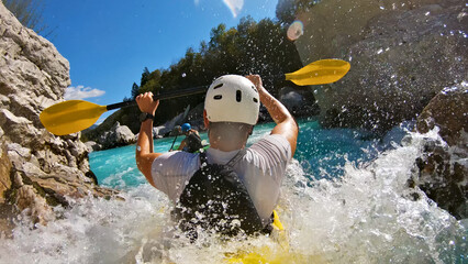 A thrilling kayaking adventure unfolds as a man, donned in a white helmet and life jacket,...