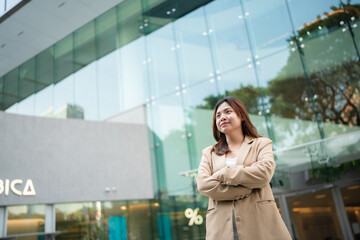 Asian business white collar confident woman standing outside office city building