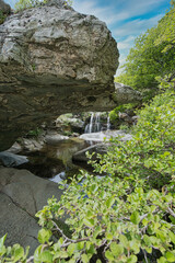 Small Waterfall in Lush Forest on Andros Island, Greece..
