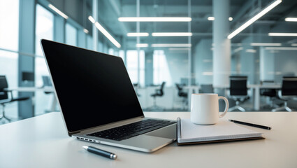 High-Tech Startup Office Workspace with Silver Laptop and Glass Wall Background