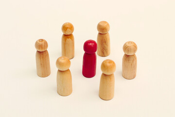 Group of wooden man icons and one red wooden man icon on isolated background