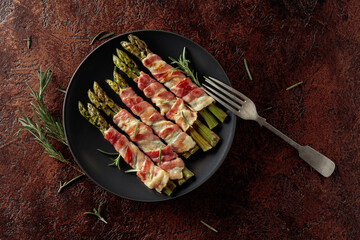 Grilled green asparagus wrapped in bacon.