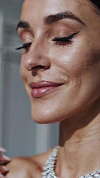 Close-up angle capturing elegance, showcasing a woman's jewelry with a focus on earrings and necklace, styled for a luxury fashion video.