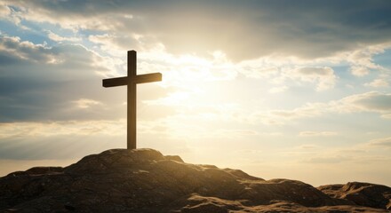 A Silhouette of a Christian Cross on a Rocky Hilltop Against a Dramatic Sky with Sunrays and Clouds