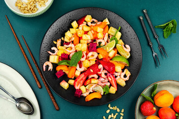 Tasty seafood salad and exotic fruits.