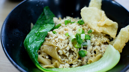a bowl of dumplings with noodles and shredded chicken