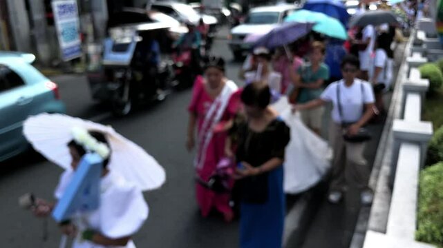 Mayflower pageantry tradition, elderly women dressed in traditional Filipino gowns parade the streets in honor of Helena, also known as Reyna Elena. Blurs