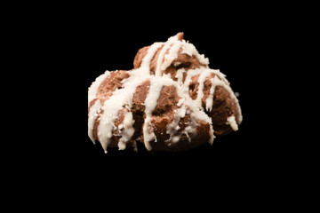 Profiteroles with coconut cream on a black background.