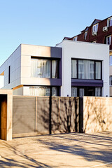 Fragment of beautiful modern house of white color of cubic shapes. Vertical photo.