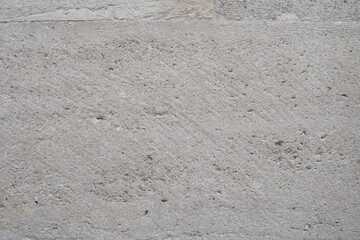 Old stone, concrete wall texture close-up. Wall background with rough stone surface