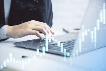 Business person analyzing forex market data using laptop with digital financial chart overlay on office desk background for investment strategy concept.