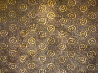 Close up of brown carpet flooring with repeated spiral patterns. Suitable for carpet flooring or rug. Seamless background texture.