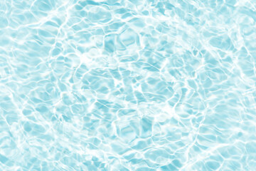 Blue water with ripples on the surface. Defocus blurred transparent blue colored clear calm water surface texture with splashes and bubbles. Water waves with shining pattern texture background.