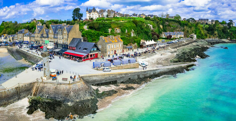 France travel, most scenic traditional villages in Brittany - beautiful Cancale, famous for oysters and turquoise sea. High angle drone panorama of old town and lighthouse