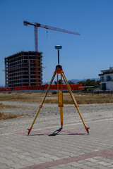Geodetic theodolite with GPS near building site on sunny day in Cyprus