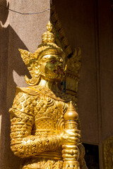 Fototapeta premium Colorful guard Yaksha statue in a Buddhist temple Wat in Thailand. Golden Statue guardian sacred creatures mystical and mythological relic of Thai Buddhism religion. Decoration of thai buddhist pagoda