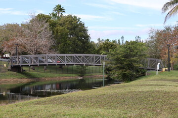 wooden bridge in the park across the canal river