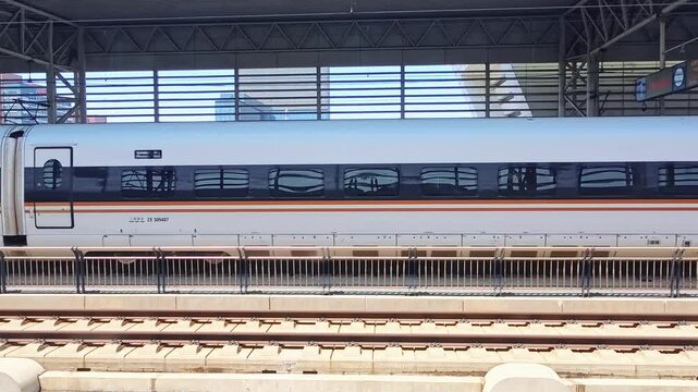 Qingdao,China-May.25.2025:Video footage of a Chinese high-speed train slowly entering a high-speed rail station
