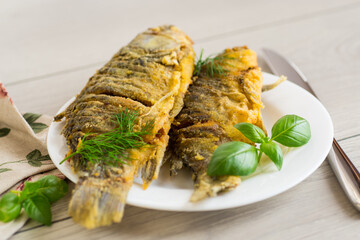 Traditional Ukrainian fried crucian carp in a village kitchen