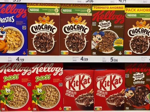 Palmanova, Spain - May 24, 2025: Colorful cereal boxes displayed on supermarket shelf featuring Kellogg's and Nestle brands, showcasing various flavors and appealing designs for breakfast options