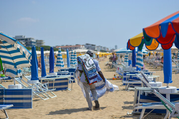 a street vendor among the deckchairs on the beach