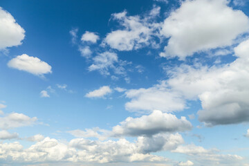 Blue sky with white cumulus fluffy clouds background texture
