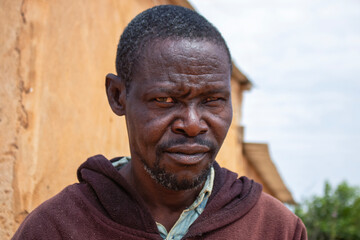 Portrait of a real elderly African man with deep wrinkles and expressive eyes. A natural and emotional image capturing human strength, wisdom, and timeless character.