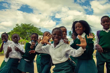 Real photo of happy black African kids in school uniforms, smiling and enjoying a break. A positive image of youth, education, diversity, and community spirit. © Yuliia Lakeienko