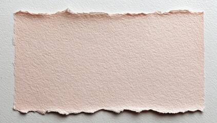 A piece of torn, light peach-colored paper