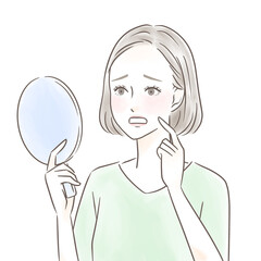 手鏡を見て口の中のトラブルにショックを受ける女性