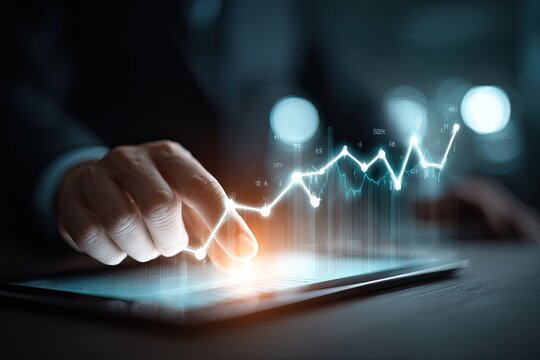 Business hand interacting with a digital graph on tablet, illustrating growth and success