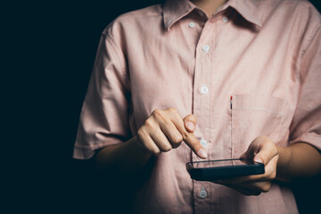 Close-Up of Person Using Smartphone with Light Touch in Dark Environment for Technology and Communication Themes
