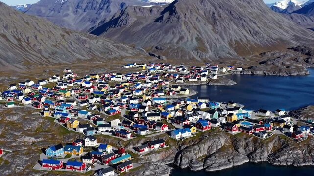 Aerial view of colorful Nuuk town nestled between mountains and sea  